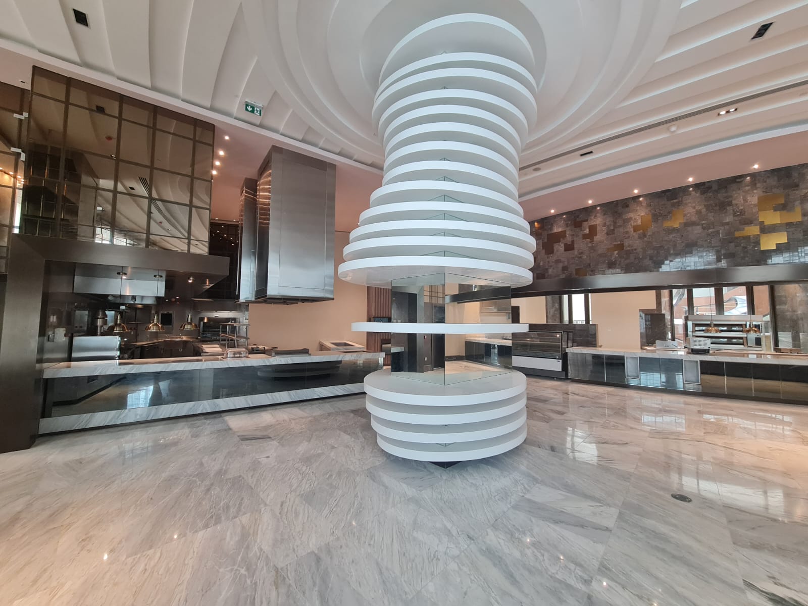 Commercial kitchen and service counter with sculptural ceiling feature